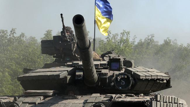 Ukrainian troops ride a tank on a road of the eastern Ukrainian region of Donbas in June. Picture: AFP