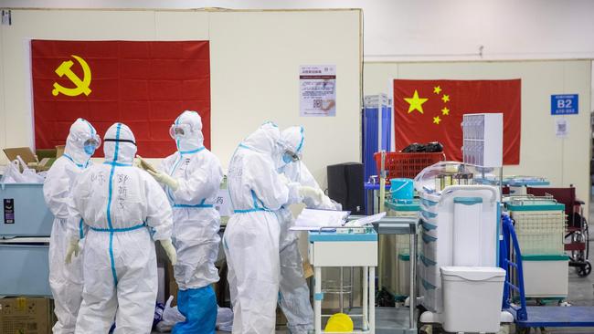 Medical staff members work at an exhibition centre converted into a hospital in Wuhan in China's central Hubei province. Picture: AFP