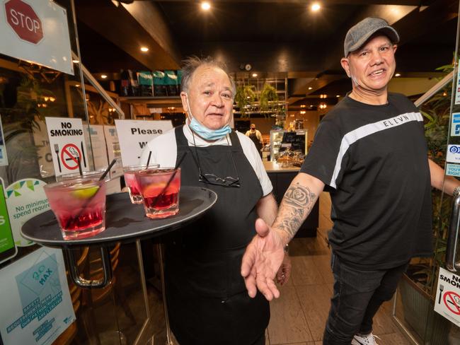 Stavros Manavakis and George Leveque getting ready to let customers in after a long lockdown. Picture: Tony Gough