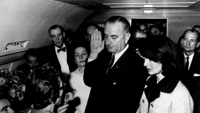 Lyndon B. Johnson is sworn in as President of the United States in the cabin of the presidential plane as Jacqueline Kennedy stands at his side, on November 22, 1963. Picture: AP