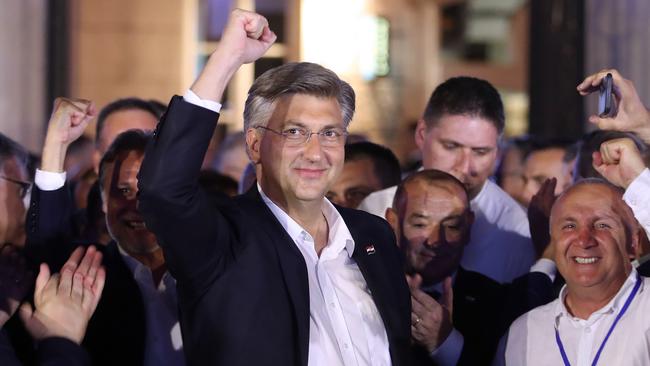 Croatian Prime Minister and leader of the Croatian Democratic Union party (HDZ) Andrej Plenkovic celebrates with party members. Picture: AFP