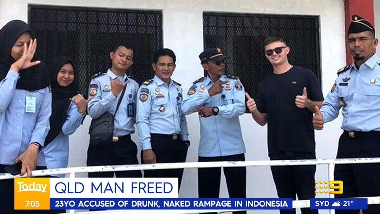 He posed with police upon his release. Picture: Nine News