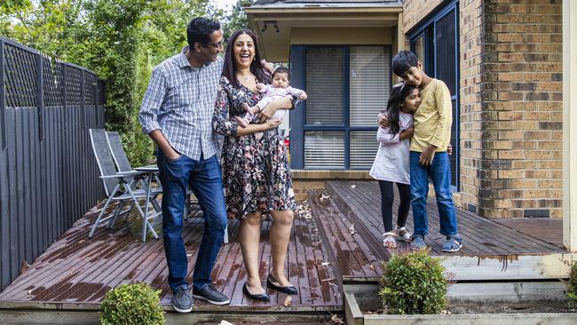 Melbourne couple Anita and Shankar Krishnan with kids Devan, 7, Tanisha, 4, and Arya, 10 weeks. They are building a bigger home with plenty of partitions and work spaces. Picture: Aaron Francis