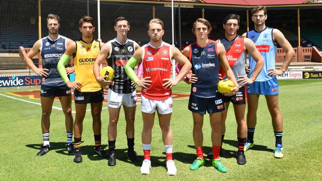 Players from seven of the SANFL clubs in Fast Footy guernseys for a promotional shot at Norwood Oval ahead of the pre-season competition in 2018. From left, Keegan Brooksby (South Adelaide), Cameron Buchanan (Glenelg), Sam Davison (Port Adelaide), Michael Virgin (North Adelaide), Chris Olsson (Norwood), Lochie Peter (West Adelaide) and Tom Read (Sturt). Picture: AAP/Keryn Stevens