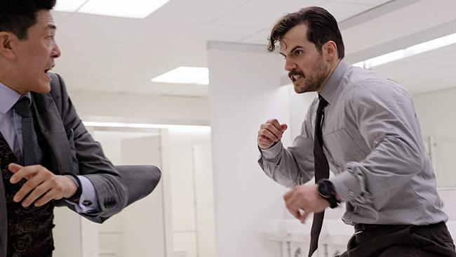 Toilet humour: Henry Cavill and Liang Yang duke it out in the men’s room.