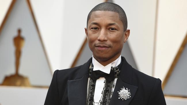 Finally a male fashion statement! Pharrell Williams in Chanel. Complete with man brooch. Picture: AP