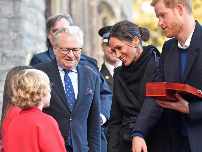 Harry Smith and Megan Taylor, both from Marlborough Primary School, present a wedding gift to Prince Harry and his fiancee Meghan Markle during their visit to Cardiff Castle on January 18, 2018 in Cardiff, Wales. Picture: Getty