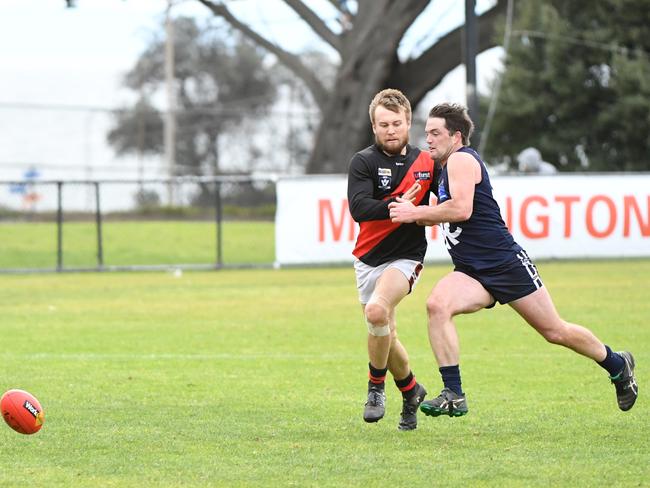 Rosebud's Brenton Payne (right) tries to beat his Frankston opponent to the ball.