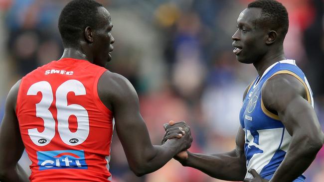 Aliir Aliir (left) and Majak Daw (right) shake hands after Sydney beat North Melbourne in Hobart. Picture: Getty