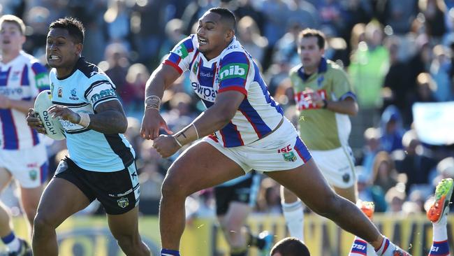 Ben Barba of the Sharks beats the tackle of Pauli Pauli.