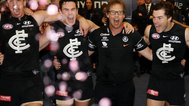 Carlton players celebrate their first win under David Teague last season.