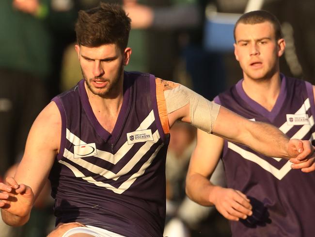 EFL (Division 3) footy: The Basin v Templestowe.19 Adrian Fancellu kicks the ball for Templestowe as he is tackled by Josh Adams for the Basin.Picture: Stuart Milligan