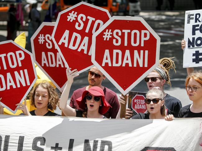 Protestors are seen outside the Queensland Resources Council (QRC) Annual 'State of the Sector' Lunch at the Brisbane Convention and Exhibition Centre in Brisbane, Tuesday, November 21, 2017. (AAP Image/Glenn Hunt) NO ARCHIVING