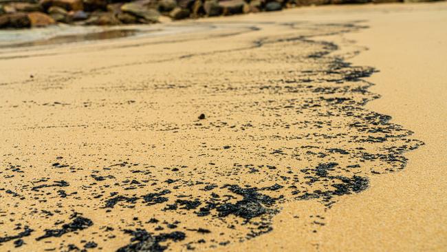 Ash and debris can still be found on the sand.