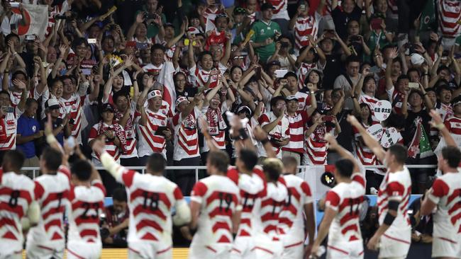 Japan players wave to supporters after the famous win. Picture: AP