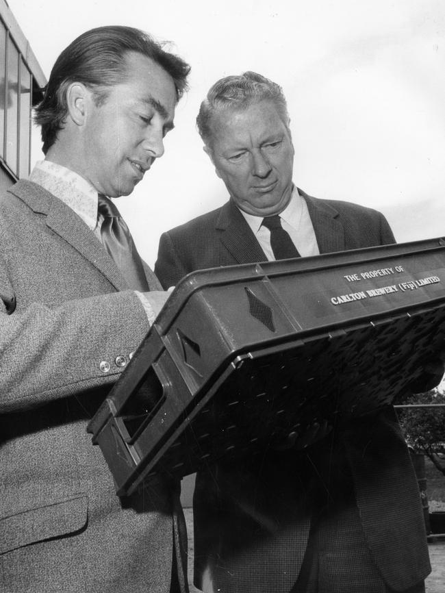 Castalloy Ltd managing director Frederick Henry “Harry” Phipps, right, inpsection a special order of plastic crates to be sent to Carlton Brewery Ltd with SA Premier Don Dunstan in 1971.