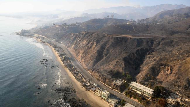 In this aerial view taken from a helicopter, burned homes are seen during the Palisades fire in the Malibu area of Los Angeles. Picture: AFP