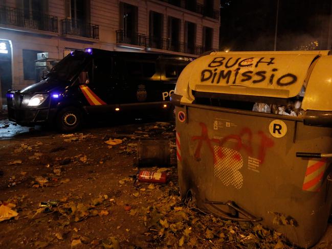 A police van drives over debris in Barcelona, on October 18, 2019, after violence escalated during clashes, with radical separatists hurling projectiles at police. Picture: AFP