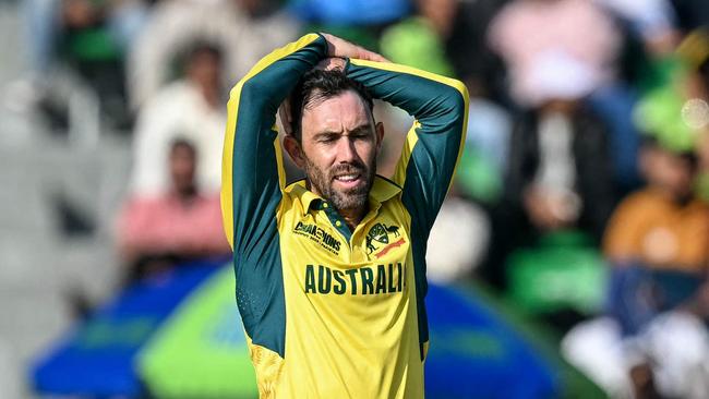 TOPSHOT - Australia's Glenn Maxwell (L) reacts after a delivery during the ICC Champions Trophy one-day international (ODI) cricket match between Australia and England at the Gaddafi Stadium in Lahore on February 22, 2025. (Photo by Aamir QURESHI / AFP)