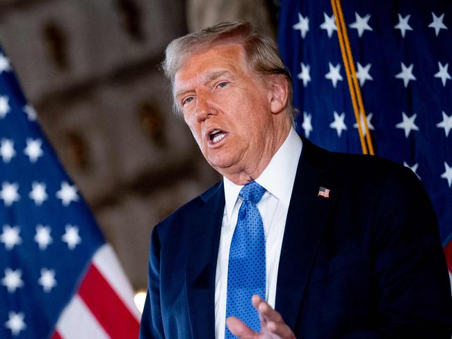 PALM BEACH, FLORIDA - DECEMBER 16: U.S. President-elect Donald Trump, accompanied by Trump's choice for Secretary of Commerce, Cantor Fitzgerald Chairman and CEO Howard Lutnick, speaks at a news conference at Trump's Mar-a-Lago resort on December 16, 2024 in Palm Beach, Florida. In a news conference that went over an hour, Trump announced that SoftBank will invest over $100 billion in projects in the United States including 100,000 artificial intelligence related jobs and then took questions on Syria, Israel, Ukraine, the economy, cabinet picks, and many other topics.   Andrew Harnik/Getty Images/AFP (Photo by Andrew Harnik / GETTY IMAGES NORTH AMERICA / Getty Images via AFP)