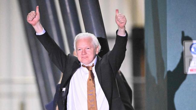 Julian Assange gives a thumbs-up at Canberra Airport. Picture: AFP