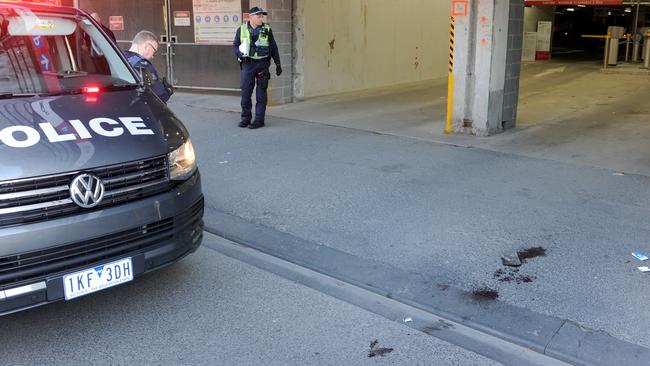 Pools of blood outside the Flinders St carpark. Picture: Andrew Henshaw