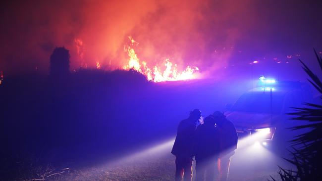 Firefighters on the scene of a bushfire that threatened homes along Palm Meadows drive and the Boonaroo park area. The blaze has reignited several times over the last week. Picture Glenn Hampson