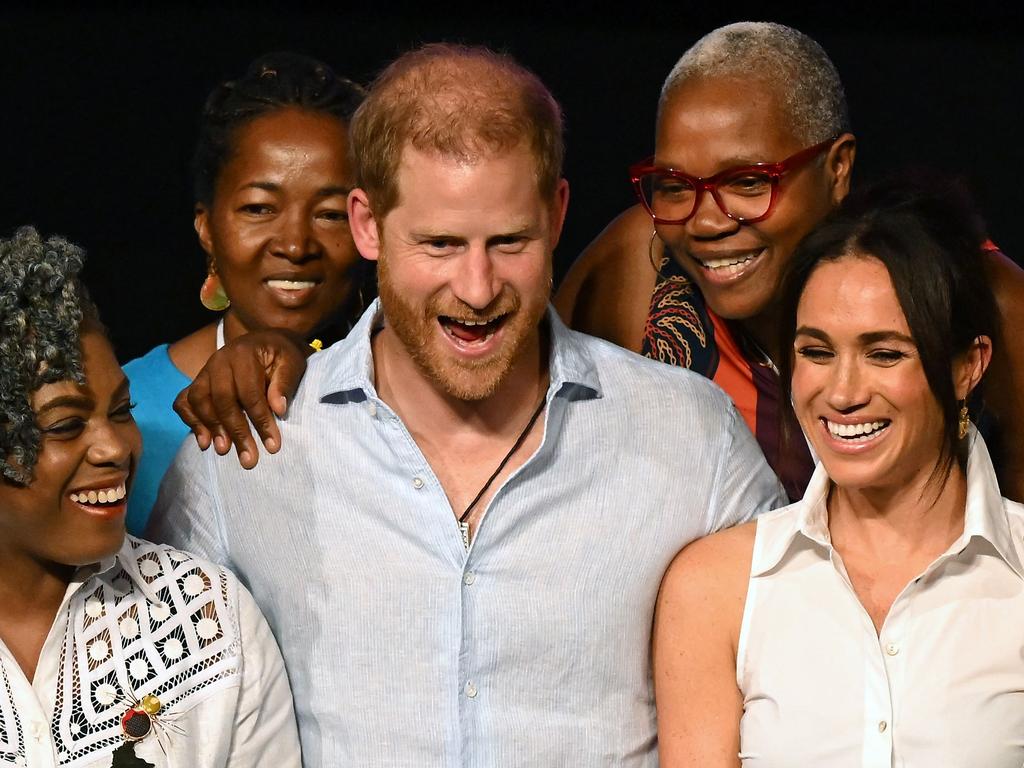 Prince Harry and Meghan Markle pose for a picture with Colombia’s former Education Minister Aurora Vergara and other participants in Cali, Colombia. Picture: AFP