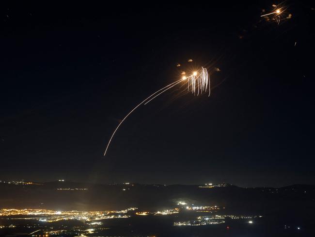 Rockets fired from southern Lebanon are intercepted by Israel's Iron Dome air defence system over the Upper Galilee region in northern Israel, on August 4. Picture: Jalaa Marey/AFP