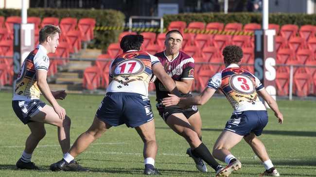 Marcus Waters (left) and Blake Cesari of St Mary’s College tackle Eli Tuli of Marsden. Photo: Nev Madsen