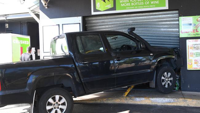 This 4WD became lodged in the Humpty Doo Thirsty Camel bottle shop roller door during an attempted ram raid on Monday morning. Picture: Katrina Bridgeford.