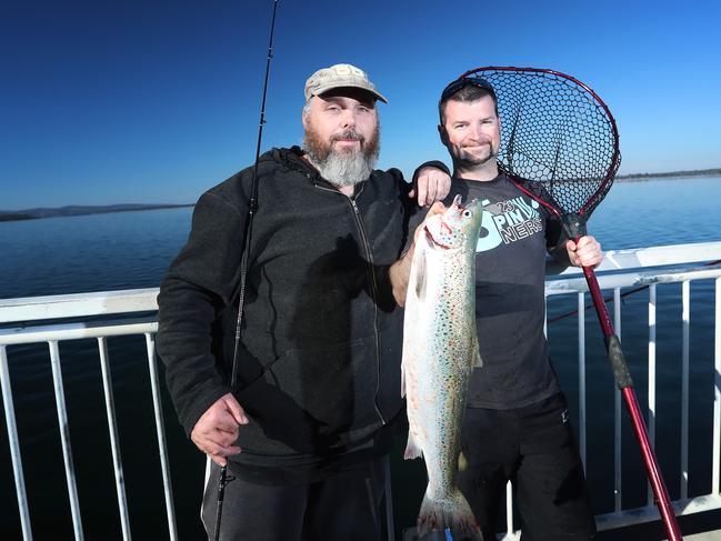 Fishermen Aaron Flakemore and Adrick MacDonald were some of the lucky ones who latched on to one of the many salmon off McGees Bridge at Midway Point. Picture: LUKE BOWDEN