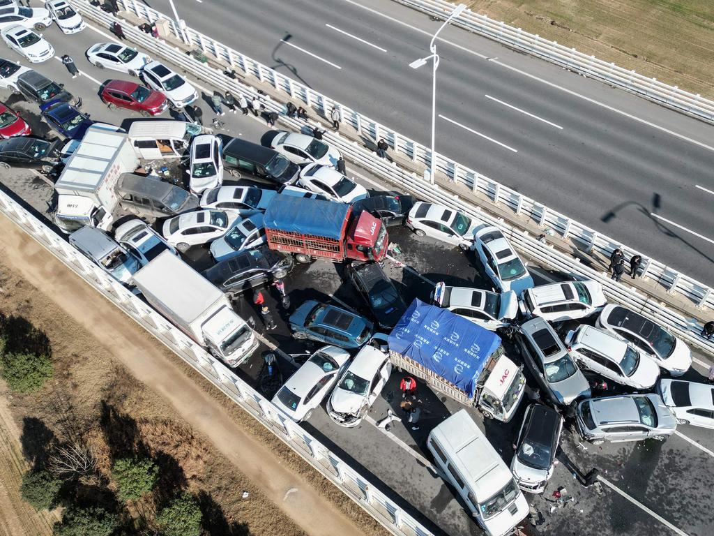 This aerial photo taken on December 28, 2022 shows a multi-vehicle collision on Zhengxin Yellow River Bridge in Zhengzhou, in China's central Henan province. (Photo by AFP) / China OUT