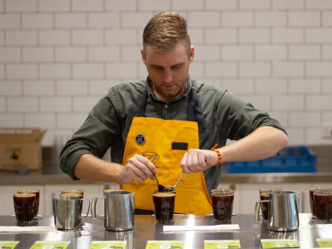 A Campos Coffee employee 'cupping' coffee at its Sydney roastery. Image courtesy of Campos.