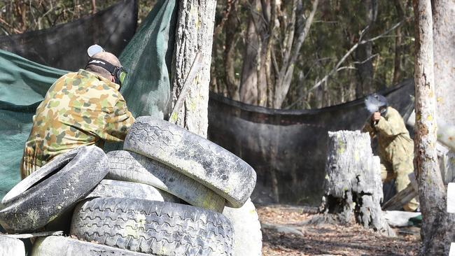 Ken Hinkley gets fired upon during paintball. Picture: Sarah Reed