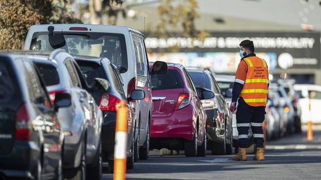 Staff direct traffic in massive queues waiting to get into a pop-up test site in Melbourne. Picture: Getty