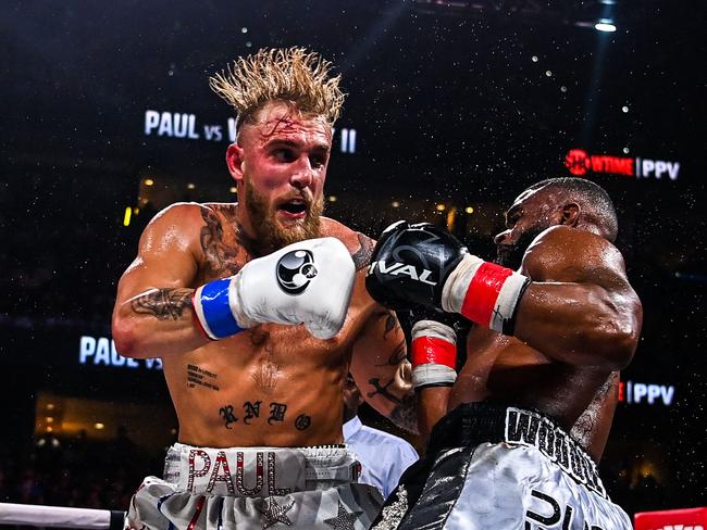 LYouTube personality Jake Paul (L) and former UFC welterweight champion Tyron Woodley fight at the Amalie Arena in Tampa, Florida, on December 18, 2021. (Photo by CHANDAN KHANNA / AFP)