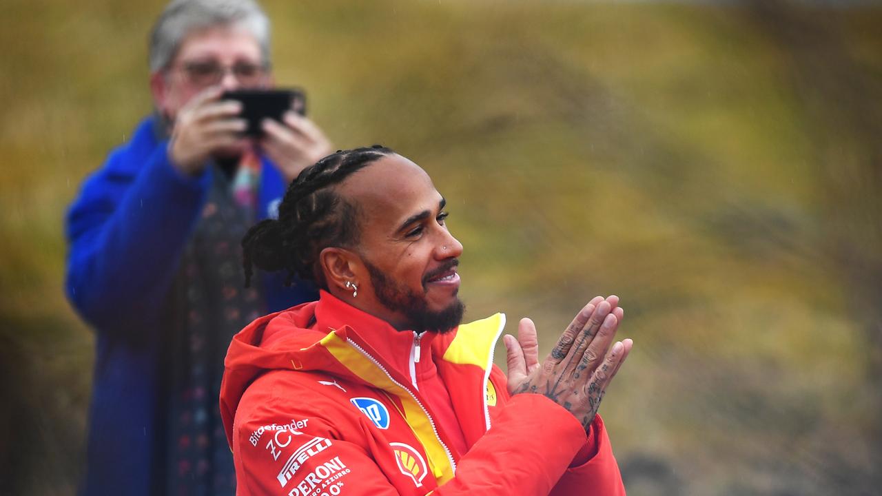 Lewis Hamilton greets Ferrari fans during his first day on track. That’s his mum in the background. (Photo by Rudy Carezzevoli/Getty Images)