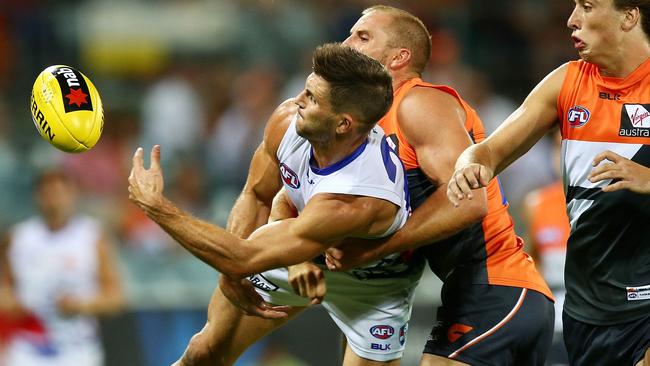 Koby Stevens gets a handball away under pressure.