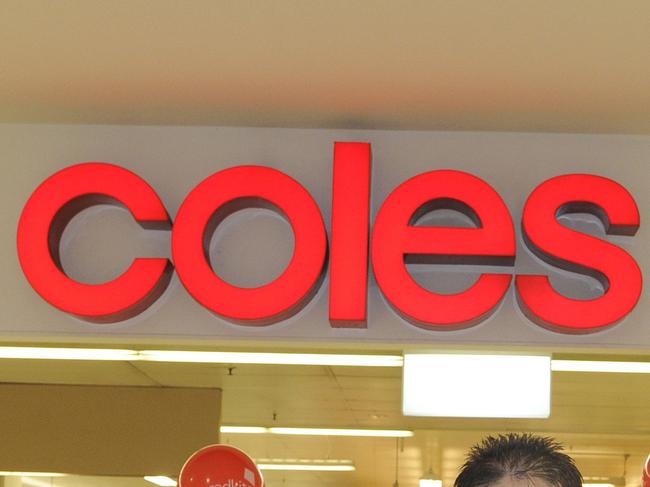 Angelo Correia (Coles Roselands Store Manager) and Deearn Hughes (Redkite) and staff at the Coles supermarket at Roselands.