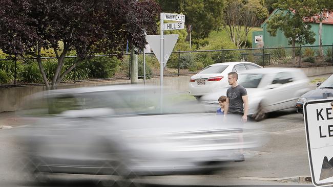 A car rushes past pedestrians waiting to cross Hill St in West Hobart. Picture: MATHEW FARRELL