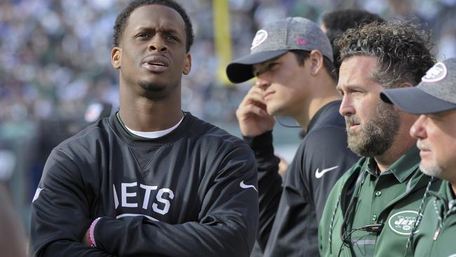 New York Jets quarterback Geno Smith watches play from the sidelines after leaving the game with a knee injury.