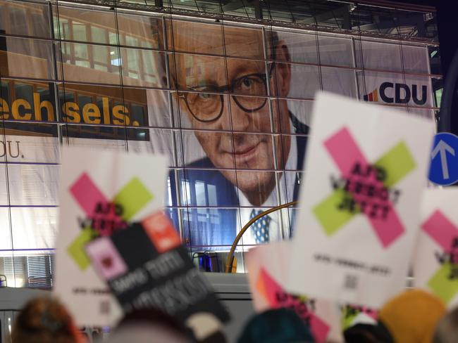 BERLIN, GERMANY - JANUARY 29: Protesters gather outside the headquarters of the German Christian Democrats (CDU), where a banner showing CDU chancellor candidate Friedrich Merz adorns the facade, after a CDU-sponsored proposal passed with the support of the far-right Alternative for Germany (AfD) at the Bundestag earlier today on January 29, 2025 in Berlin, Germany. Merz is proposing new legislation aimed at tightening immigration controls and enhancing security following a recent stabbing by an immigrant in Aschaffenburg that left two people dead. He has indicated he is open to support from the AfD in gaining passage for a potential bill, which has caused loud condemnation from other parties. Germany is scheduled to hold elections on February 23. (Photo by Sean Gallup/Getty Images)