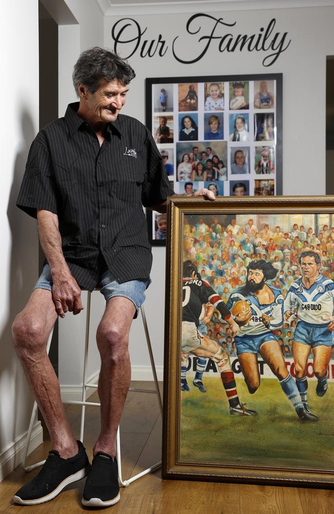 Geoff Robinson with a portrait of himself. Picture: Jonathan Ng