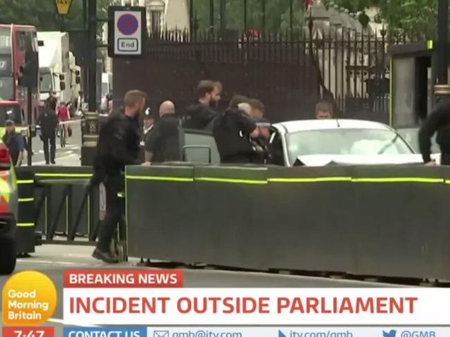 Armed police have surrounded a car and arrested a man after a number of pedestrians were hit before ploughing into security barriers outside Parliament in London. Picture: Supplied