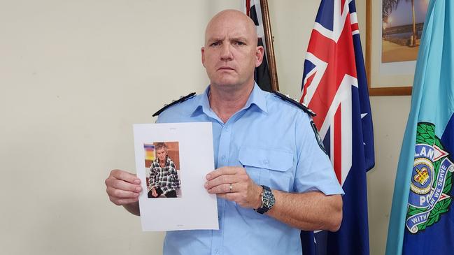 Rockhampton Patrol Group Inspector Mark Burgess holding an image of missing man Peter Roach. Picture: Aden Stokes