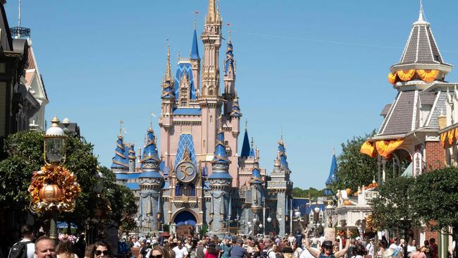 Visitors walk along Main Street at The Magic Kingdom at Walt Disney World in Orlando, Florida. Photo by Bryan R. Smith / AFP