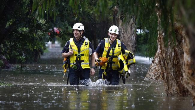 Queensland is experiencing the worst flooding in 30 years. Emergency workers in flood waters in Wilston. Picture: NCA NewsWire/Tertius Pickard