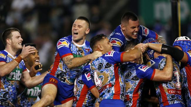 Mitchell Pearce of the Knights is mobbed by teammates after scoring a first half try during the Round 11 NRL match between the Newcastle Knights and the Sydney Roosters at McDonald Jones Stadium in Newcastle, Friday, May 24, 2019. (AAP Image/Darren Pateman) NO ARCHIVING, EDITORIAL USE ONLY