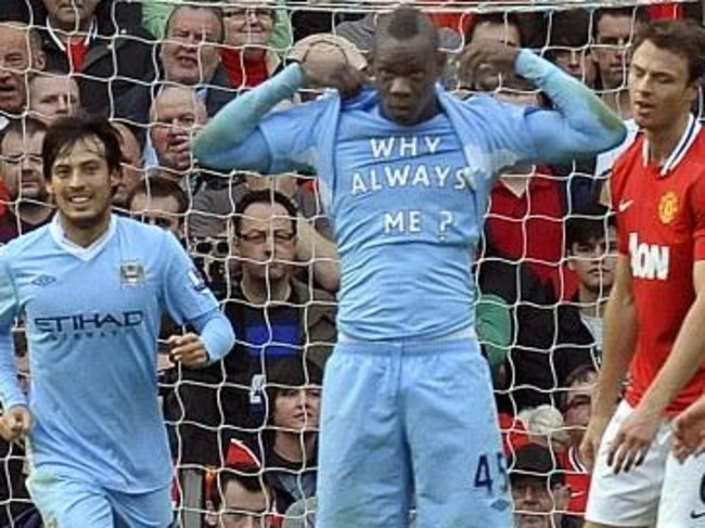 Mario Balotelli unveils his memorable shirt after scoring for City against United in 2011.